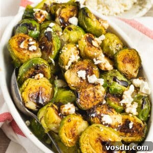 Crispy Roasted Brussels Sprouts with Feta and Lemon Zest 15 This is a square picture of a bowl of Brussels sprouts with feta and balsamic glaze.