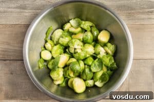 Crispy Roasted Brussels Sprouts with Feta and Lemon Zest 17 This is a picture of a bowl of Brussels sprouts seasoned with oil.