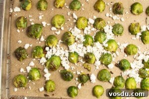 Crispy Roasted Brussels Sprouts with Feta and Lemon Zest 20 This is a picture of a baking sheet of Brussels sprouts with added feta.
