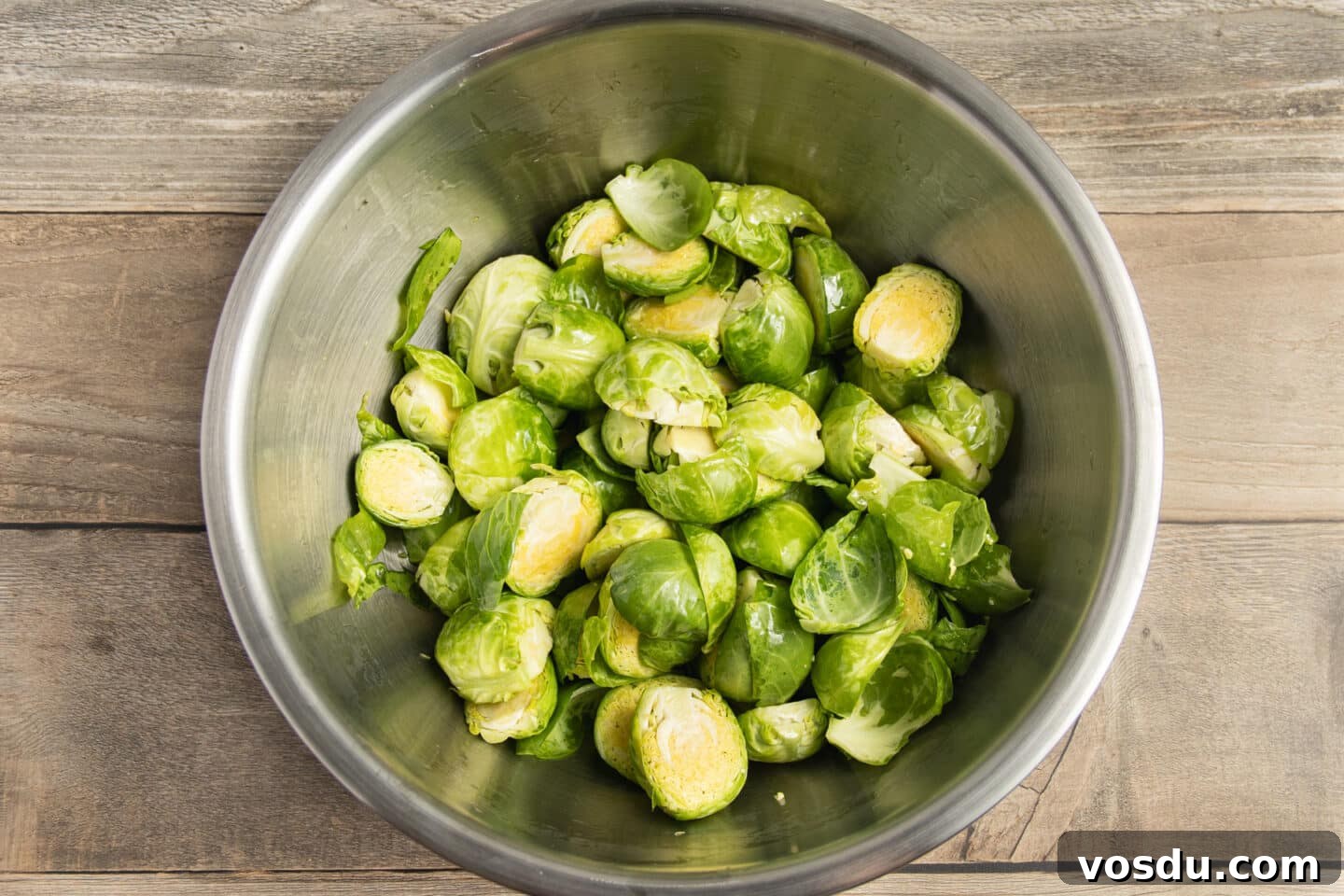 Crispy Roasted Brussels Sprouts with Feta and Lemon Zest 6 This is a picture of a bowl of Brussels sprouts seasoned with oil.