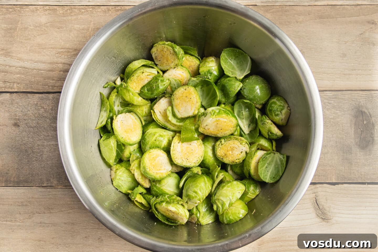 Crispy Roasted Brussels Sprouts with Feta and Lemon Zest 7 This is a picture of a bowl of Brussels sprouts seasoned with spices.