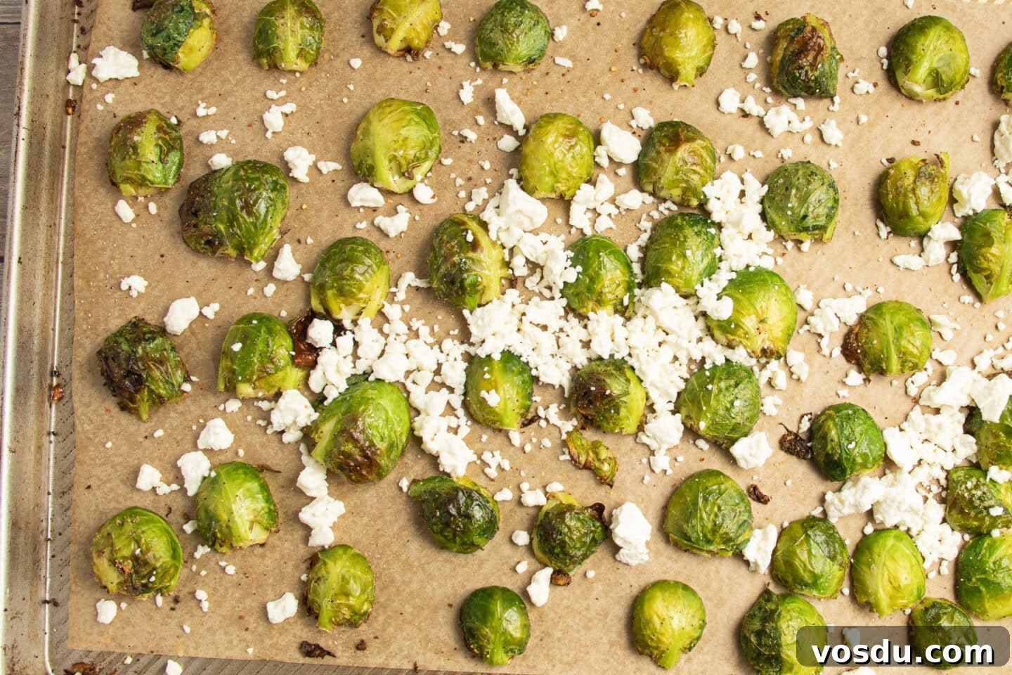 Crispy Roasted Brussels Sprouts with Feta and Lemon Zest 9 This is a picture of a baking sheet of Brussels sprouts with added feta.
