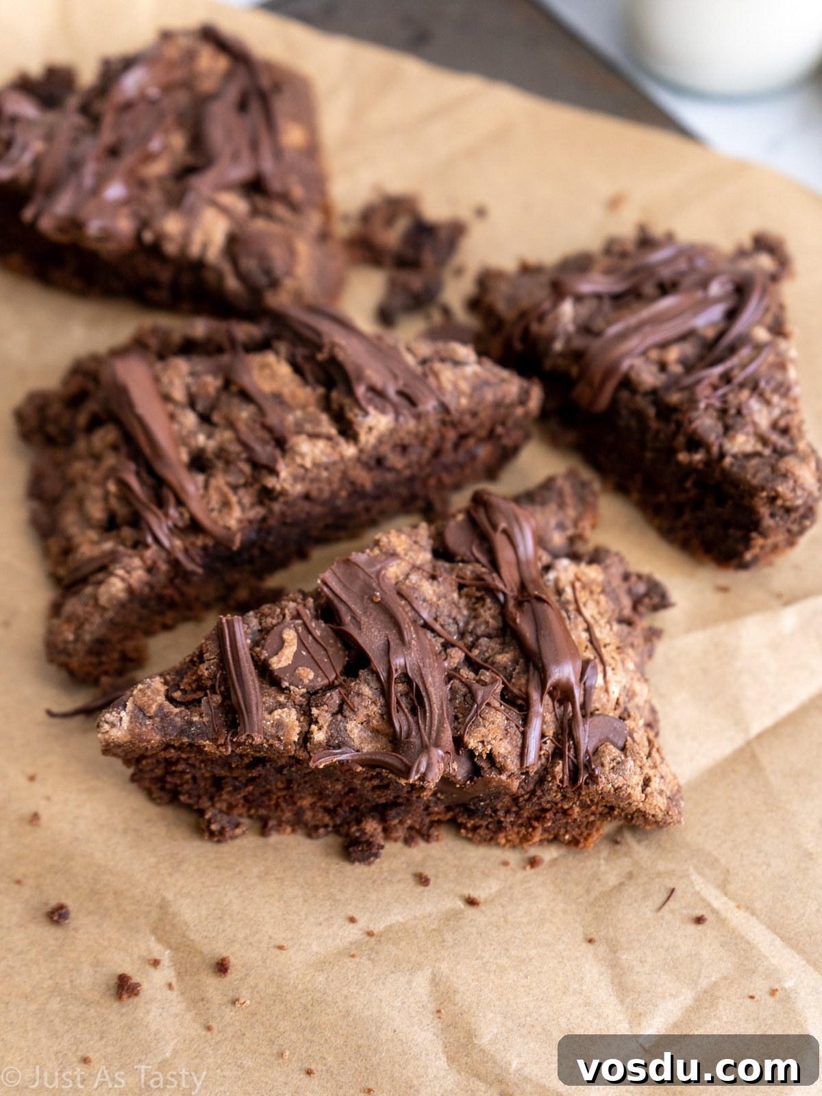 Gluten-Free Eggless Triple Chocolate Scones Recipe 2 Close-up of chocolate scones on parchment paper.