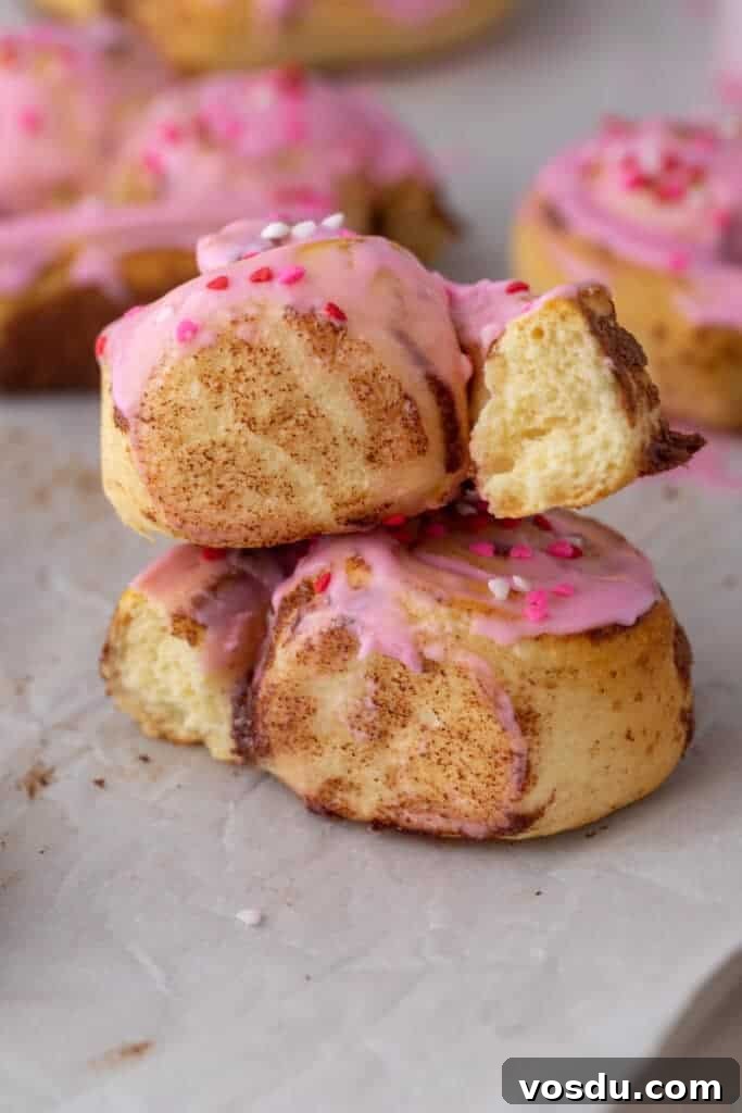 Heart-Shaped Cinnamon Rolls for Valentine’s Day Using Canned Dough 4 Stacked cinnamon rolls with pink frosting and soft centers
