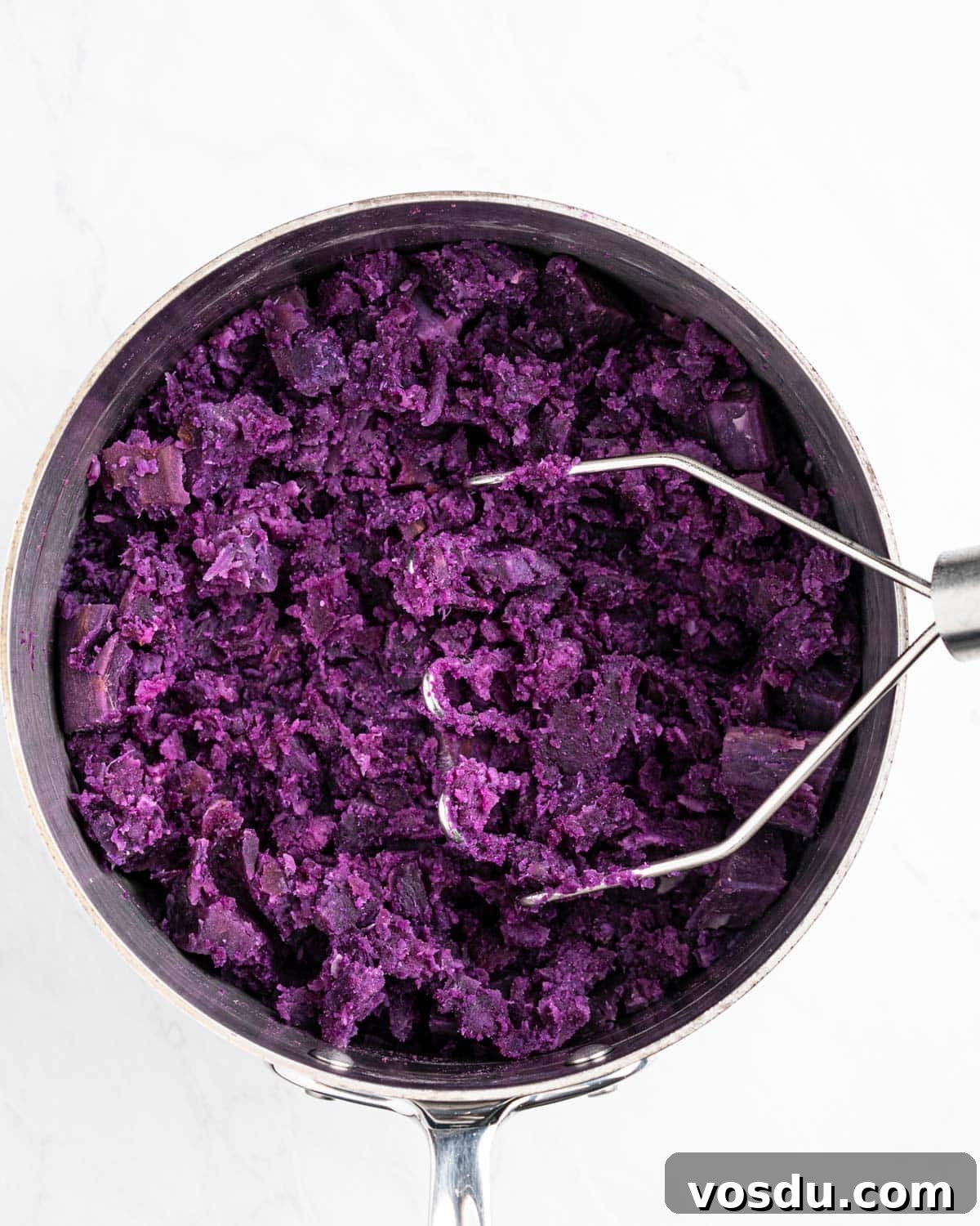 Homemade Ube Halaya (Purple Yam Jam) 5 potato masher mashing cooked purple yam.
