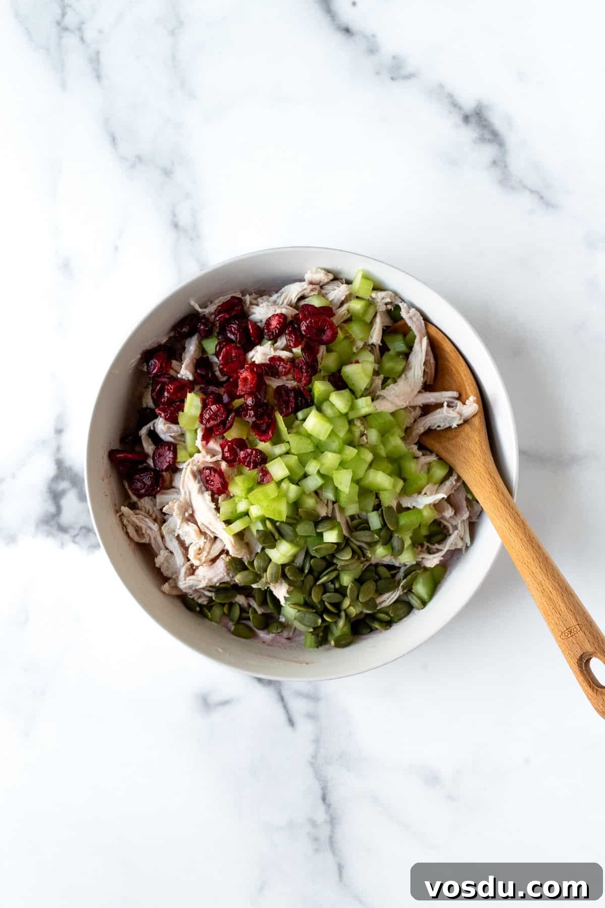 Cranberry Turkey Salad Recipe for Holiday Leftovers 5 Cranberry Turkey Salad Ingredients in a white bowl.
