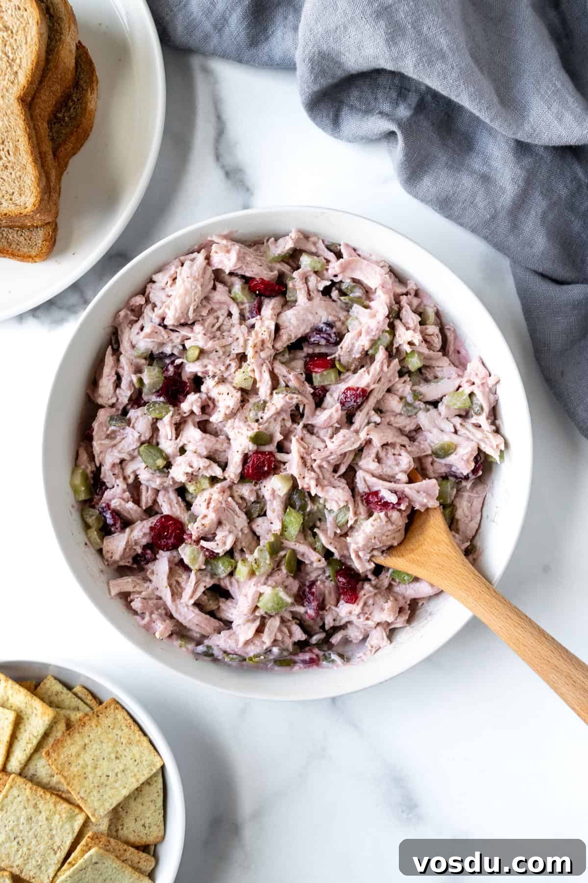 Cranberry Turkey Salad Recipe for Holiday Leftovers 6 Leftover Turkey Salad in a white bowl with a spoon.