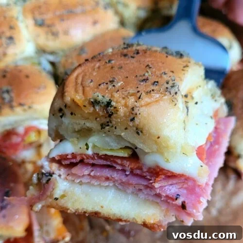 Italian Hawaiian Mini Roll Sliders Recipe 12 Mini Italian Hawaiian Roll Sliders fresh out of the oven, golden tops, melted provolone, and savory sweet sandwiches ready for a crowd-pleasing appetizer.