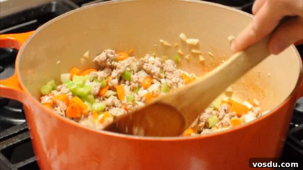 Classic Pasta e Fagioli: Hearty Italian Pasta and Bean Soup 5 Softening vegetables with sausage