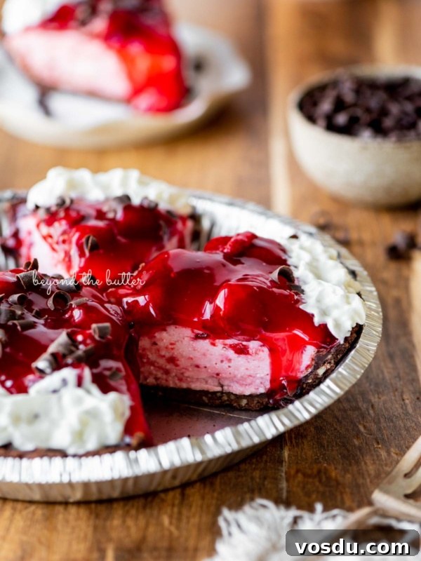 Cookies and Cream Fudge Recipe: Rich No-Bake Dessert Guide 12 Sliced no bake strawberry chocolate cream pie on wood table with a fork and small bowl of chocolate curls nearby.