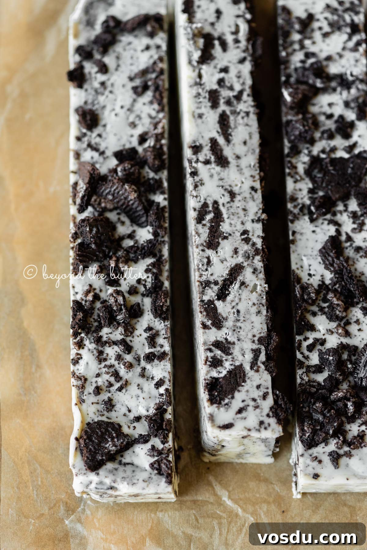 Cookies and Cream Fudge Recipe: Rich No-Bake Dessert Guide 14 Bars of cookies and cream fudge on brown parchment paper | All Images © Beyond the Butter®