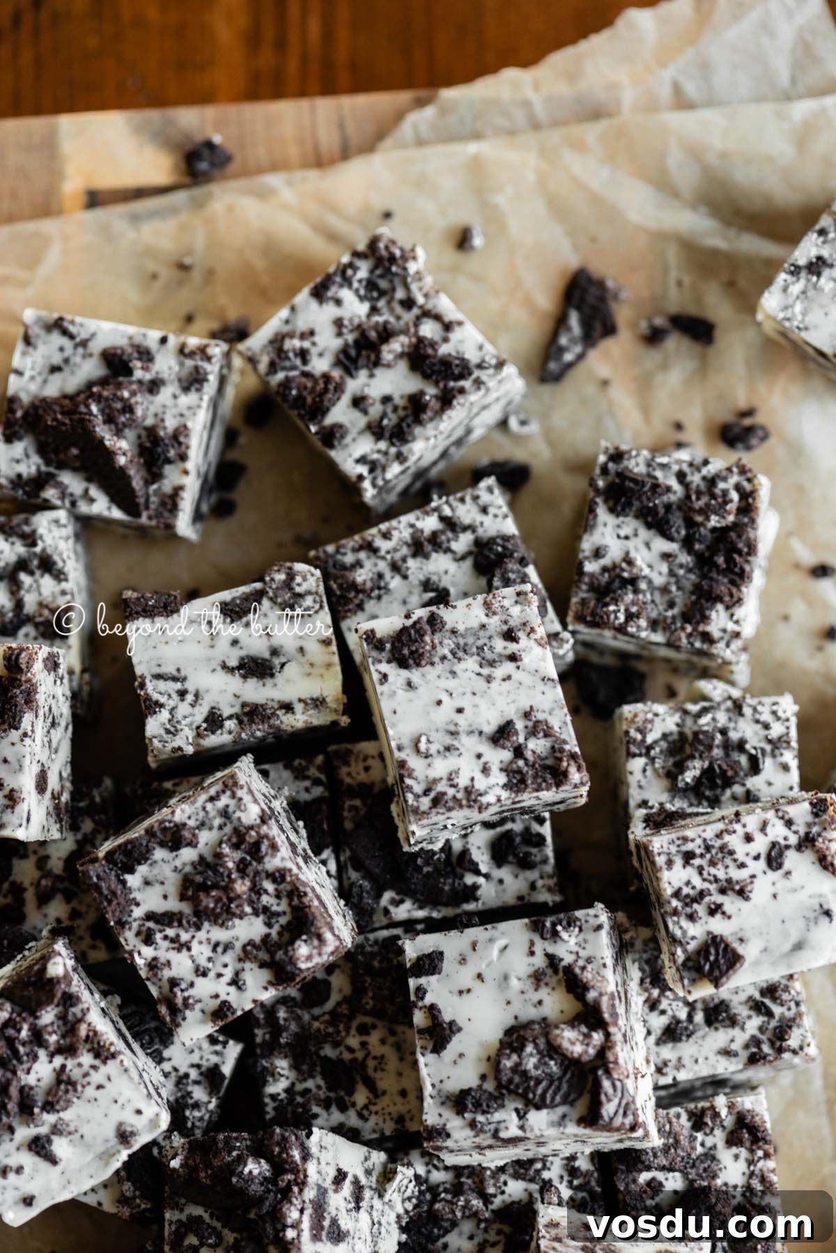 Cookies and Cream Fudge Recipe: Rich No-Bake Dessert Guide 5 Pieces of cookies and cream fudge randomly placed on top of brown parchment paper | All Images © Beyond the Butter®