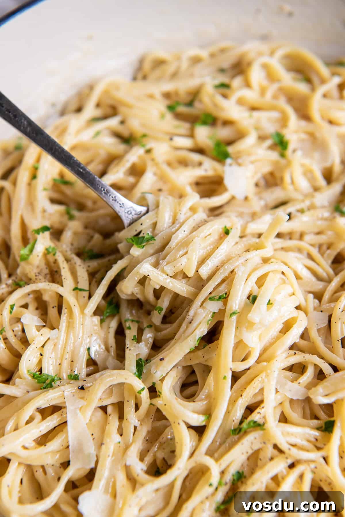 Creamy Parmesan Noodles with Garlic and Herbs 7 Linguine with Parmesan twirled around a fork.