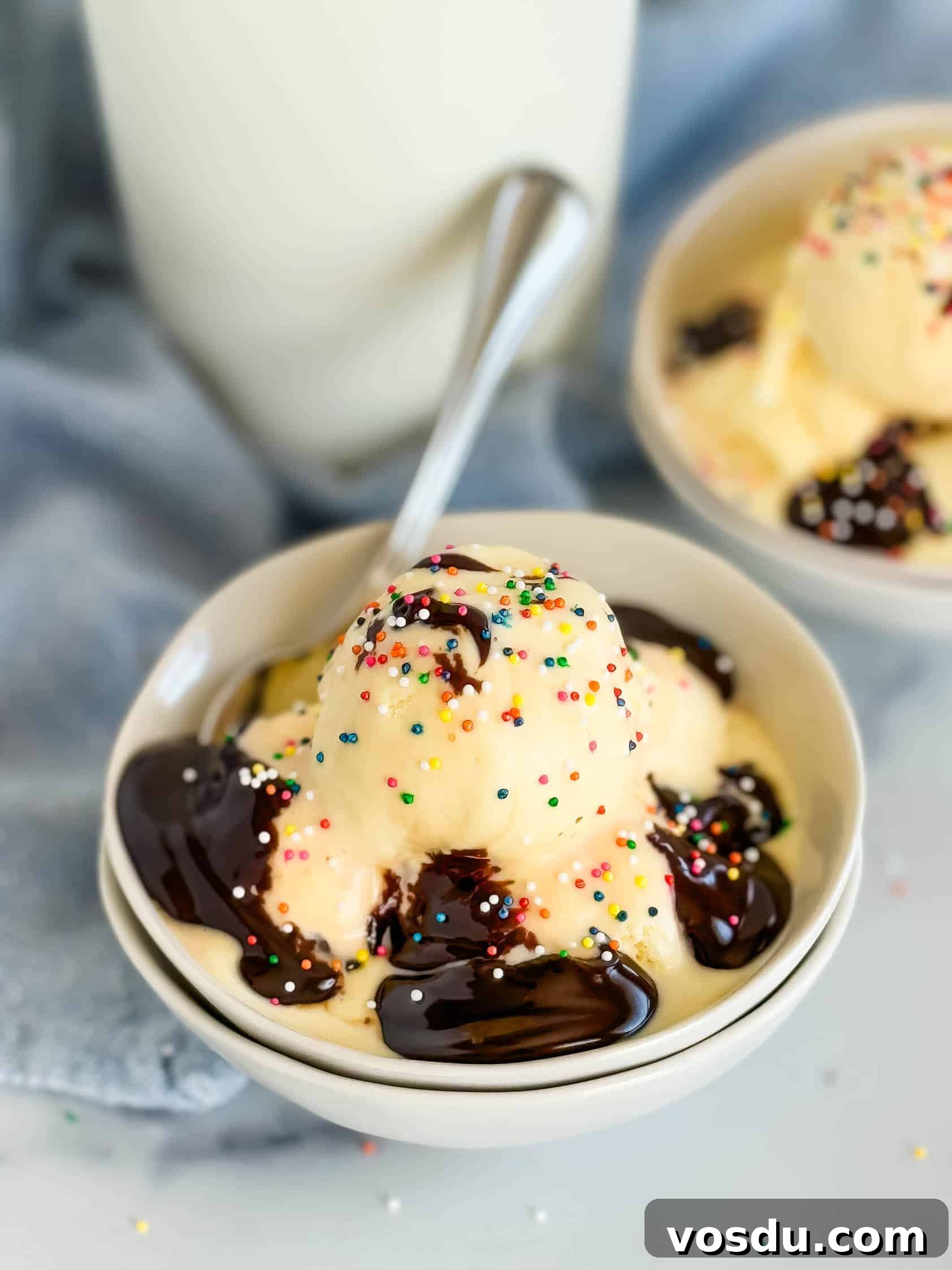 Creamy Homemade Vanilla Ice Cream Recipe You’ll Love 3 Hot fudge sauce poured over a bowl of ice cream.