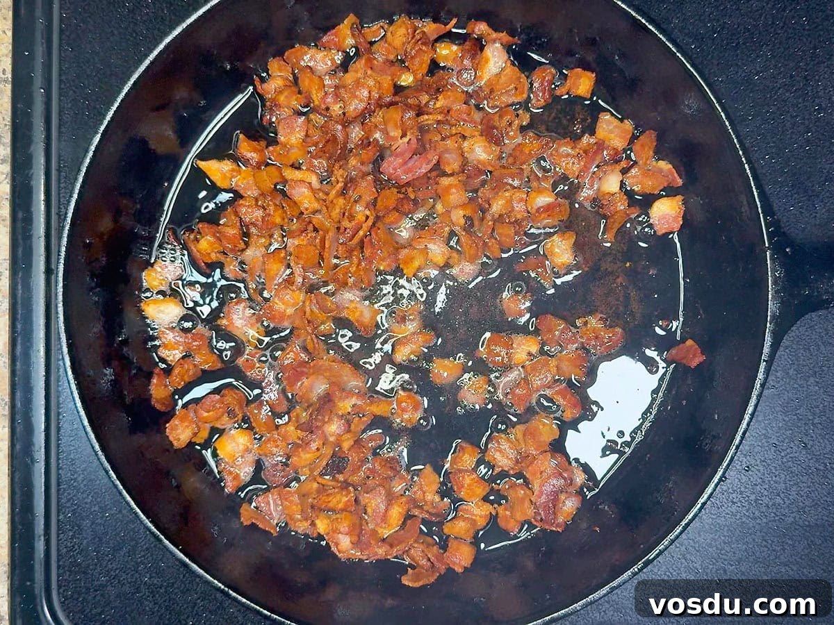 Savory Warm Bacon Vinaigrette for Salads and Vegetables 4 Cooking diced bacon pieces until crisp in a cast iron skillet.
