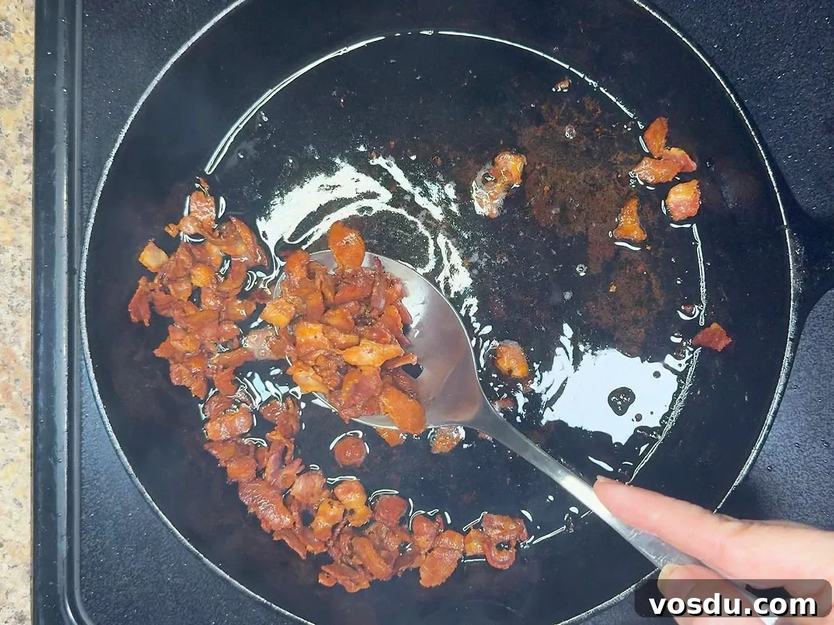 Savory Warm Bacon Vinaigrette for Salads and Vegetables 5 Removing the cooked bacon from the skillet with a slotted spoon and leaving behind the bacon grease.