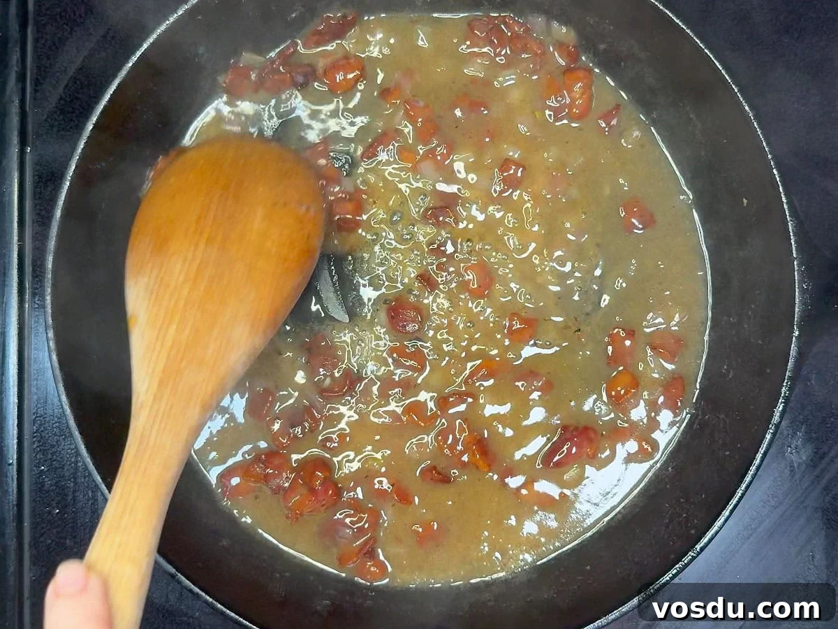 Savory Warm Bacon Vinaigrette for Salads and Vegetables 9 Stirring the cooked bacon back into the skillet with the hot bacon dressing.