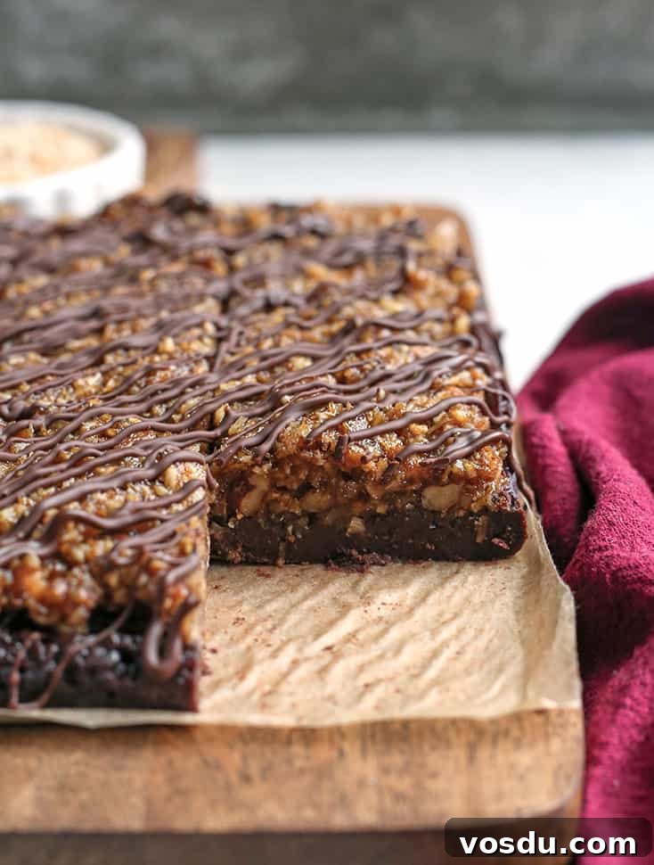 Paleo Vegan German-Style Chocolate Brownies 5 paleo vegan german chocolate brownies. One removed to show the inside.