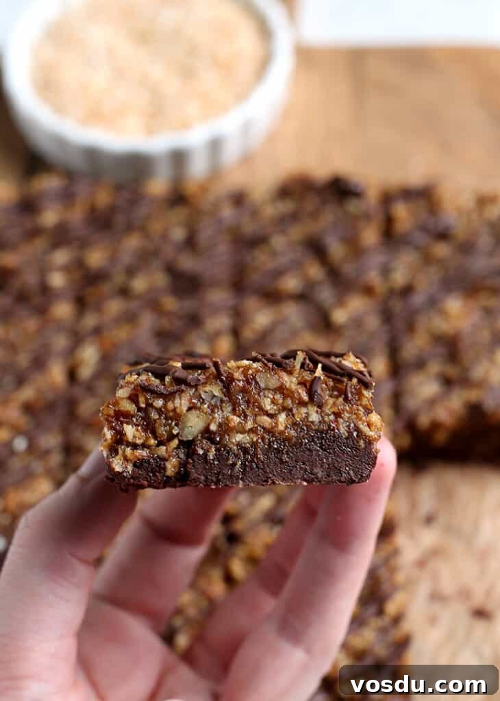 Paleo Vegan German-Style Chocolate Brownies 6 hand holding a paleo vegan german chocolate brownie