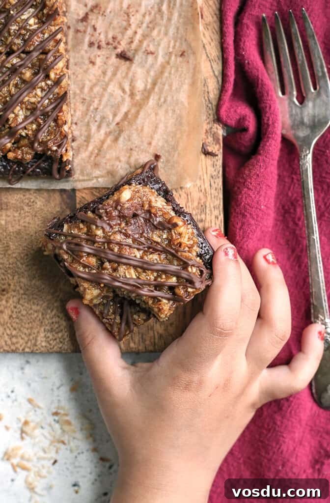 Paleo Vegan German-Style Chocolate Brownies 7 little hand grabbing a paleo vegan german chocolate brownie