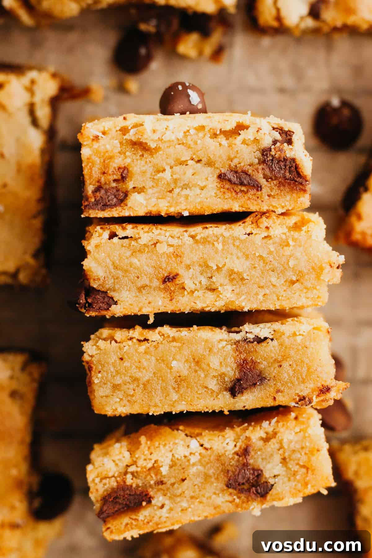Brown Butter Blondies Made in One Bowl 7 Four chocolate chip blondies on their sides stacked up.