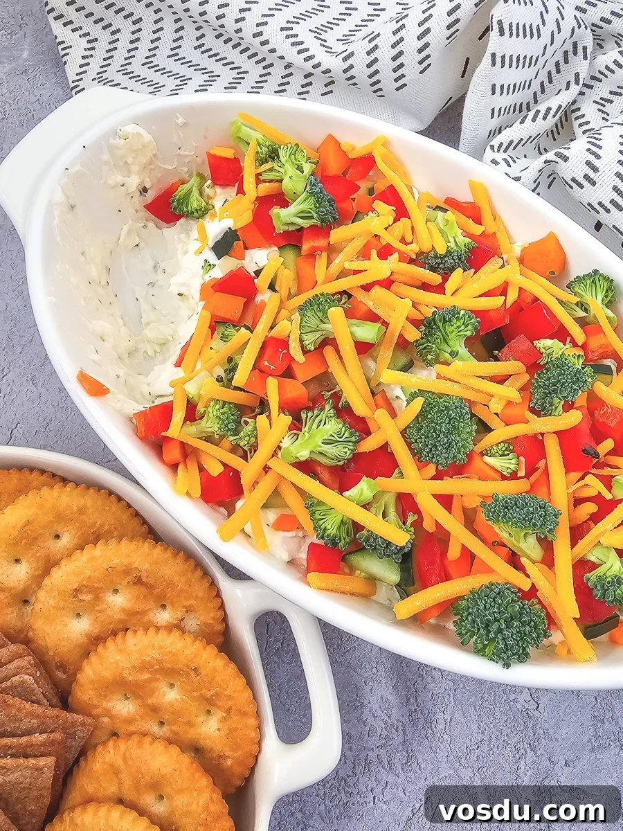 Veggie pizza dip in a white bowl.