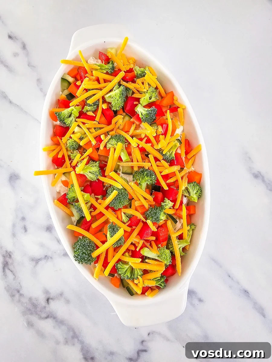 Veggie pizza dip in white bowl.