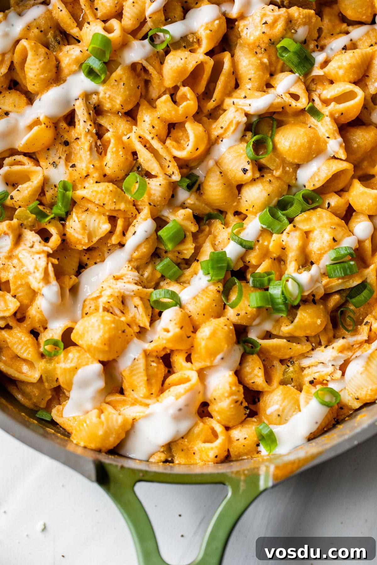 Creamy Buffalo Chicken Pasta Recipe with Tangy Wing Sauce 3 pasta and chicken in a skillet drizzled with ranch