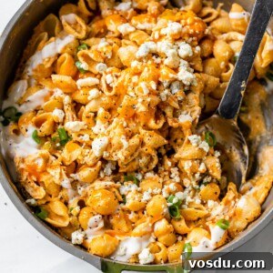Creamy Buffalo Chicken Pasta Recipe with Tangy Wing Sauce 7 a skillet filled with pasta, chicken and buffalo sauce