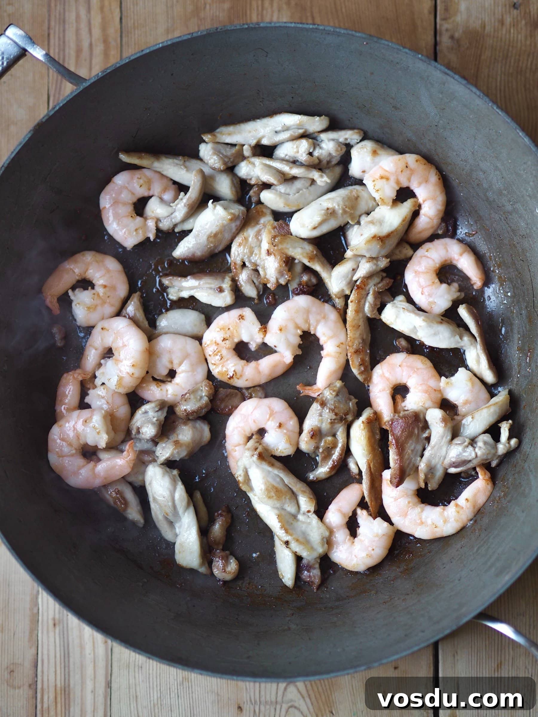 Shrimp and Chicken Fried Rice Recipe: Flavorful Weeknight Stir-Fry 5 Frying prawns and chicken strips in a pan