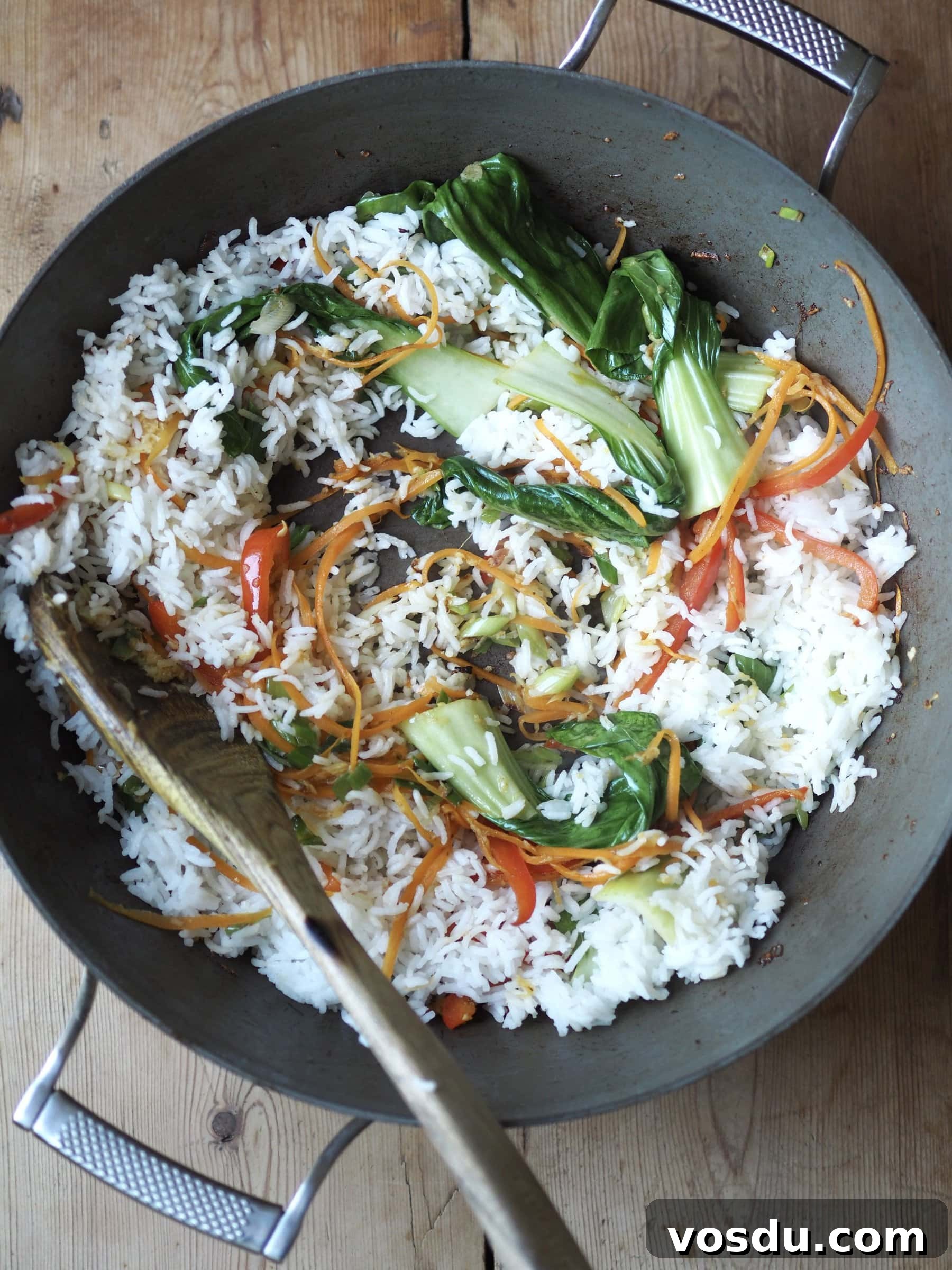 Shrimp and Chicken Fried Rice Recipe: Flavorful Weeknight Stir-Fry 7 Adding the rice in a pan with vegetables, shrimp and chicken