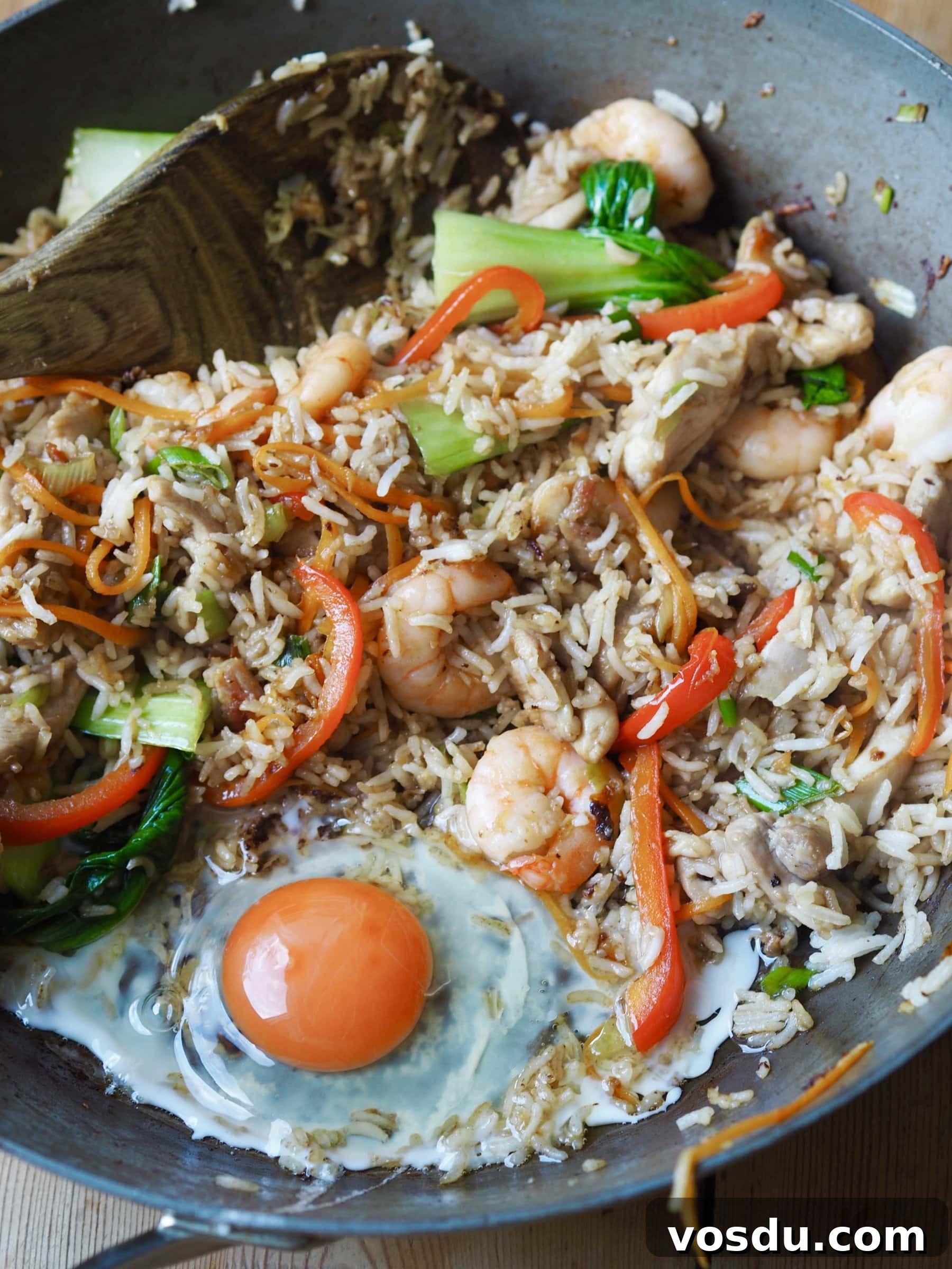 Shrimp and Chicken Fried Rice Recipe: Flavorful Weeknight Stir-Fry 8 Adding a n egg to the rice mixture