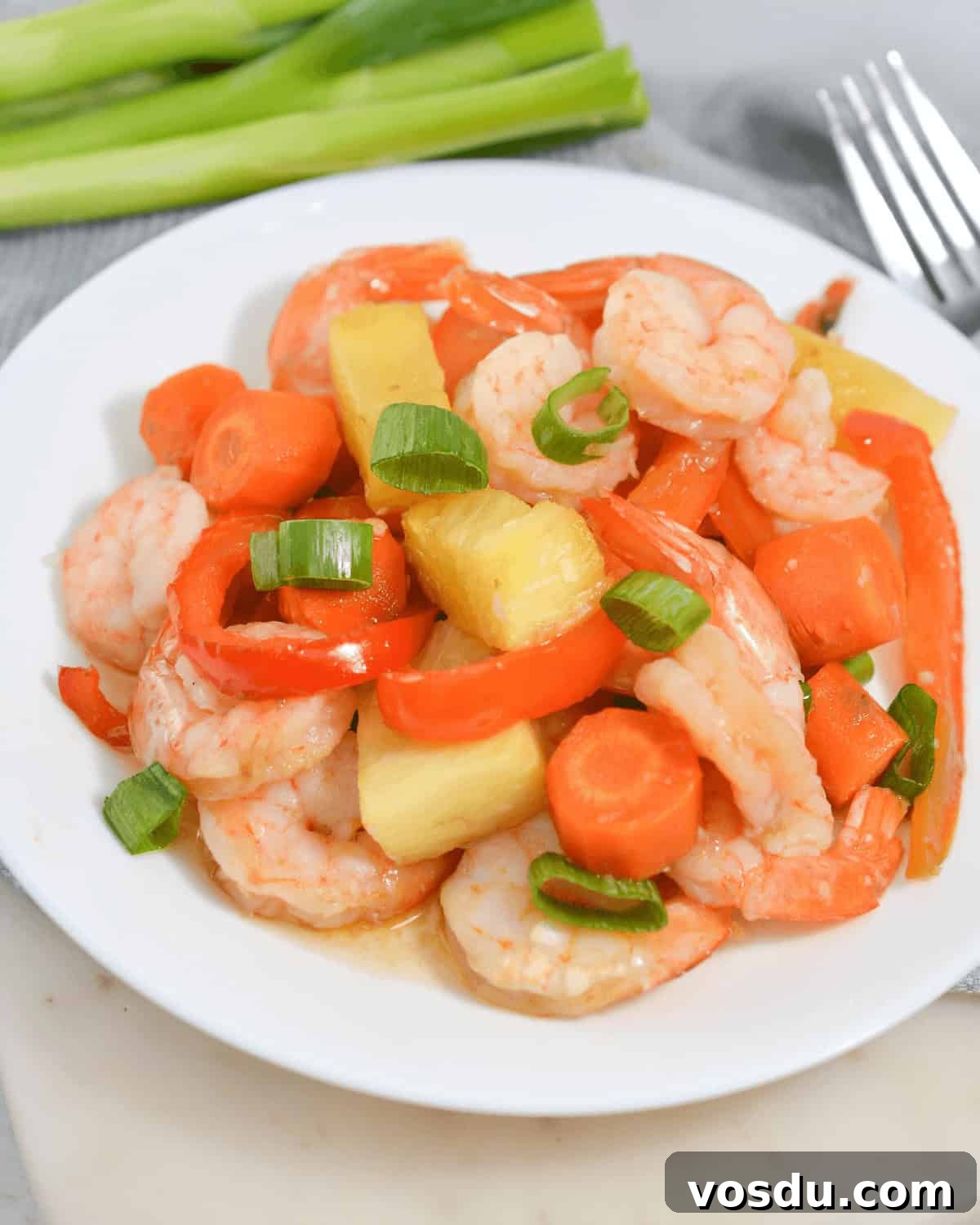 A plate with sheet pan shrimp teriyaki and pineapple.
