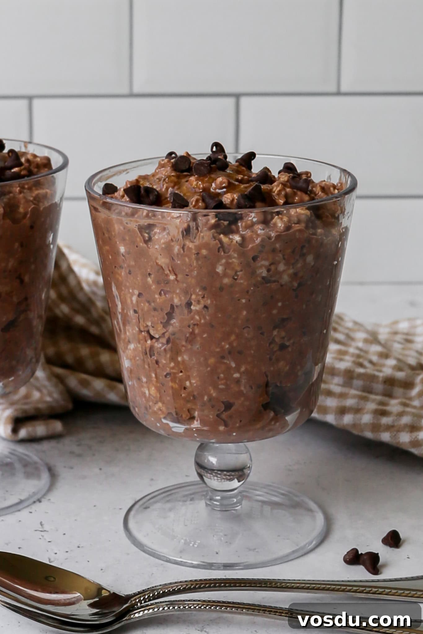 a clear sundae cup of high protein mocha overnight oats with mini chocolate chips sprinkled on top