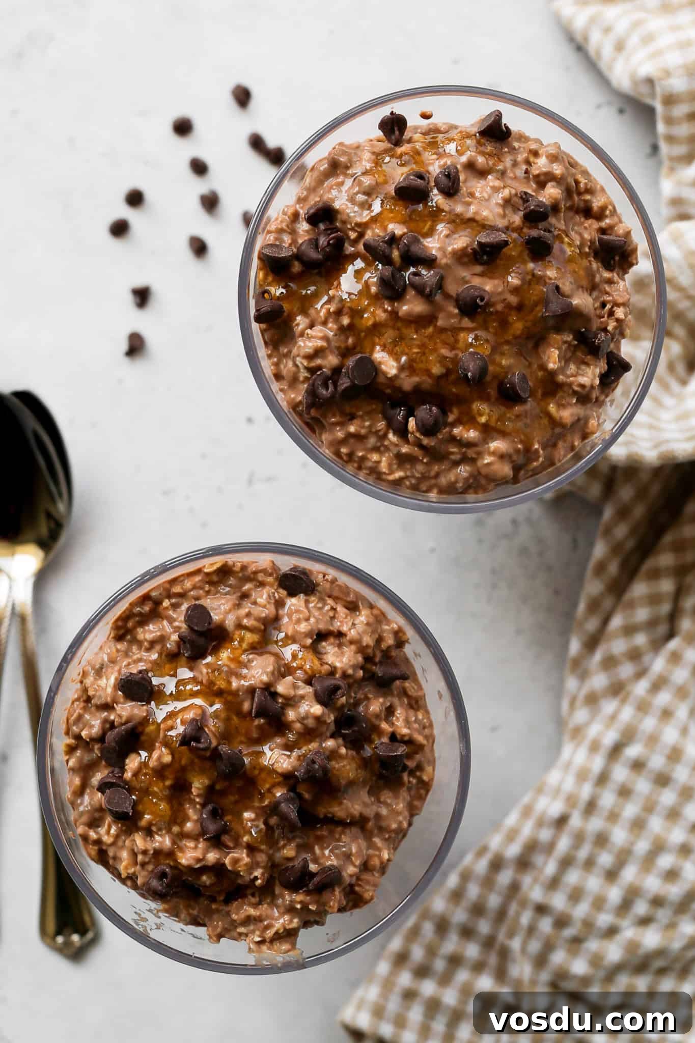 clear cups of high protein mocha overnight oats with honey drizzled on top and mini chocolate chips sprinkled on top