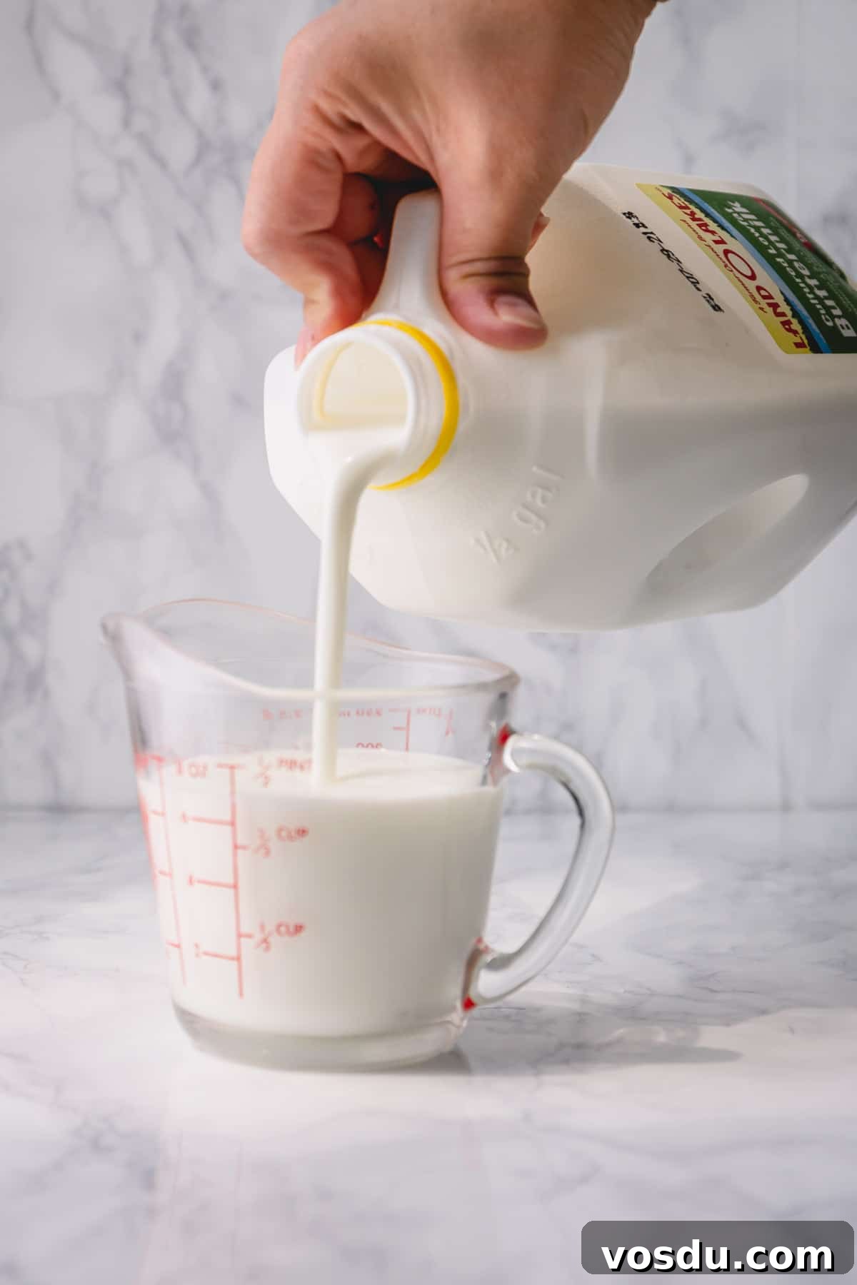 Buttermilk poured into a measuring cup