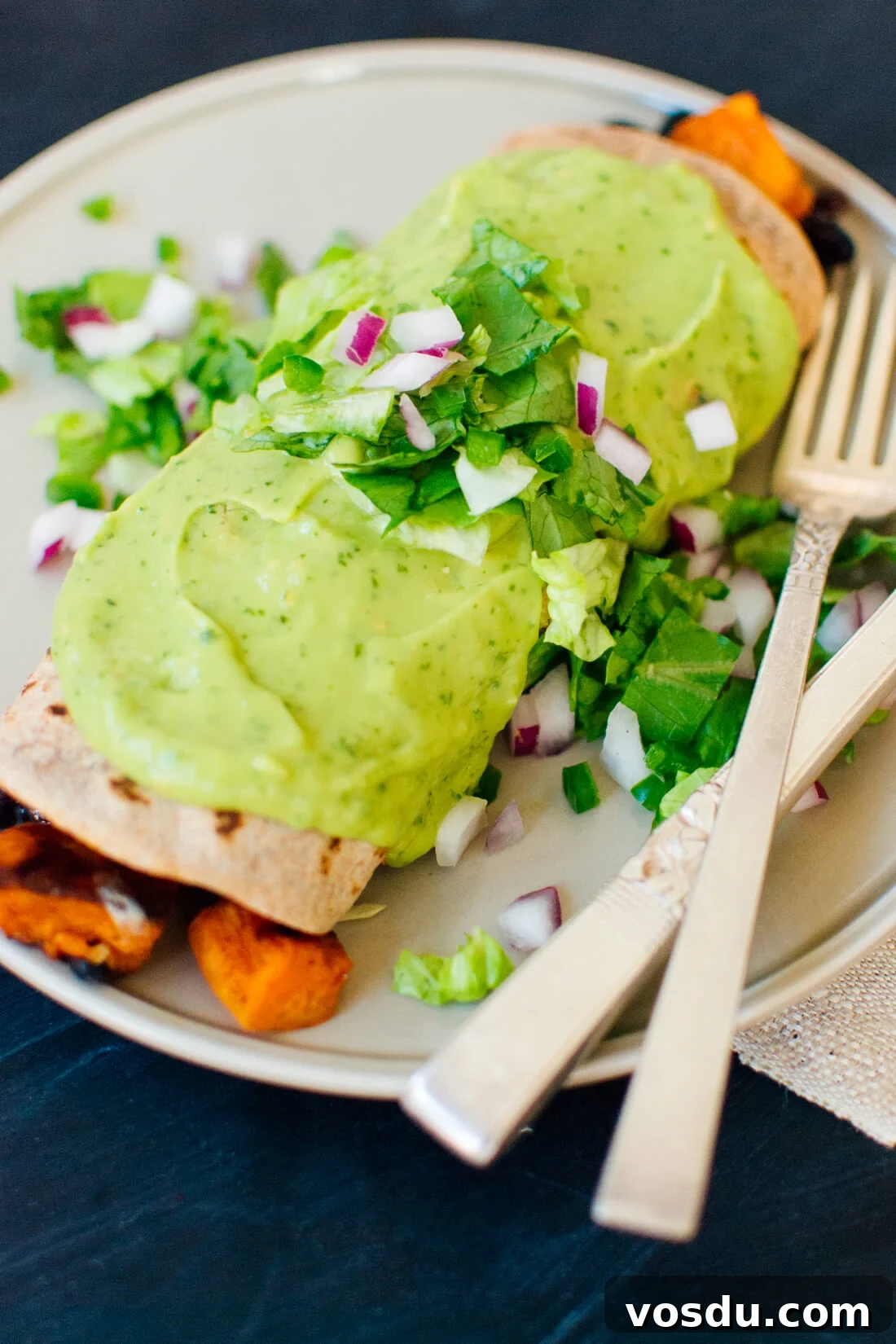 Sweet potato burrito smothered with avocado salsa verde