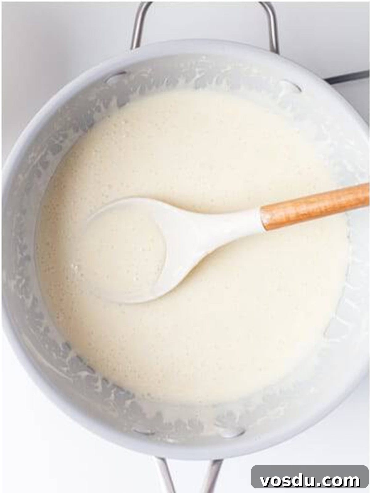 Butter and mini marshmallows melted together into a smooth mixture in a large saucepan.