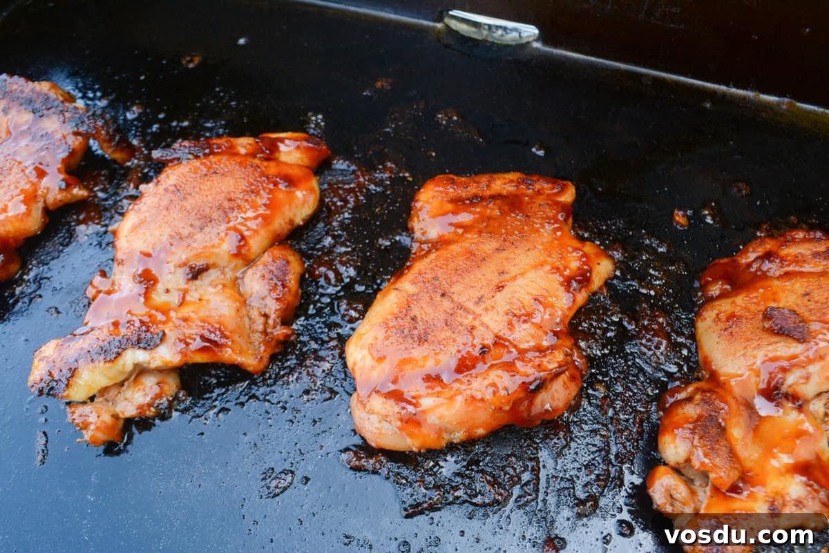 BBQ Blackstone Chicken thighs finished cooking sit on top of the Blackstone