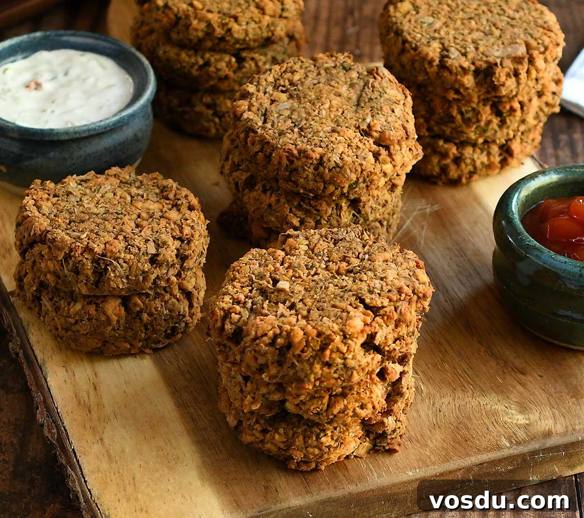 Vegan soy curl crab cakes on a wooden cutting board with dips.