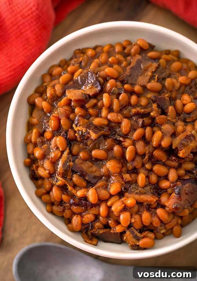 Baked Beans in a white bowl on wooden board