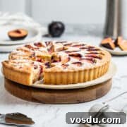 Plum frangipane tart on a serving board.