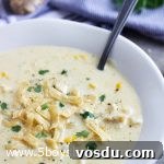 bowl of Mexican Chicken Corn Chowder with a spoon in it.