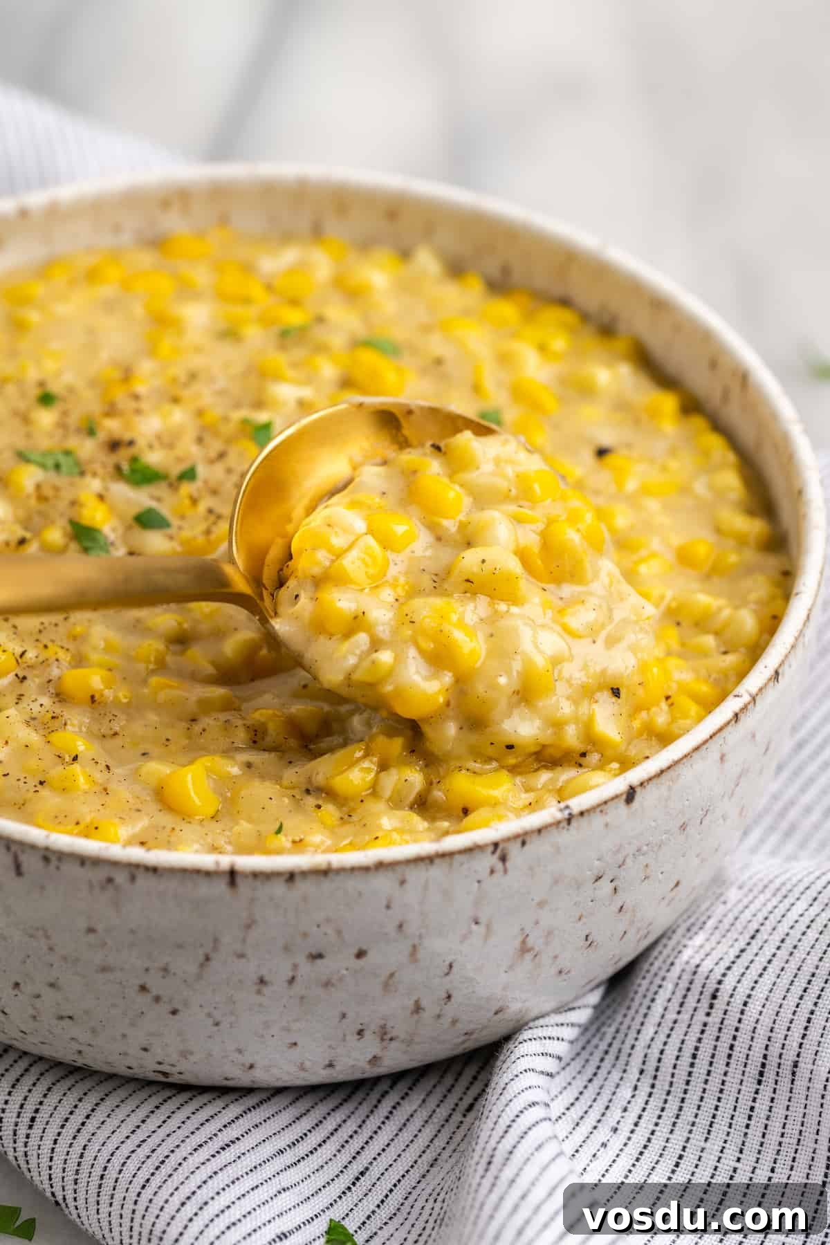 Spoon lifting vegan creamed corn from bowl