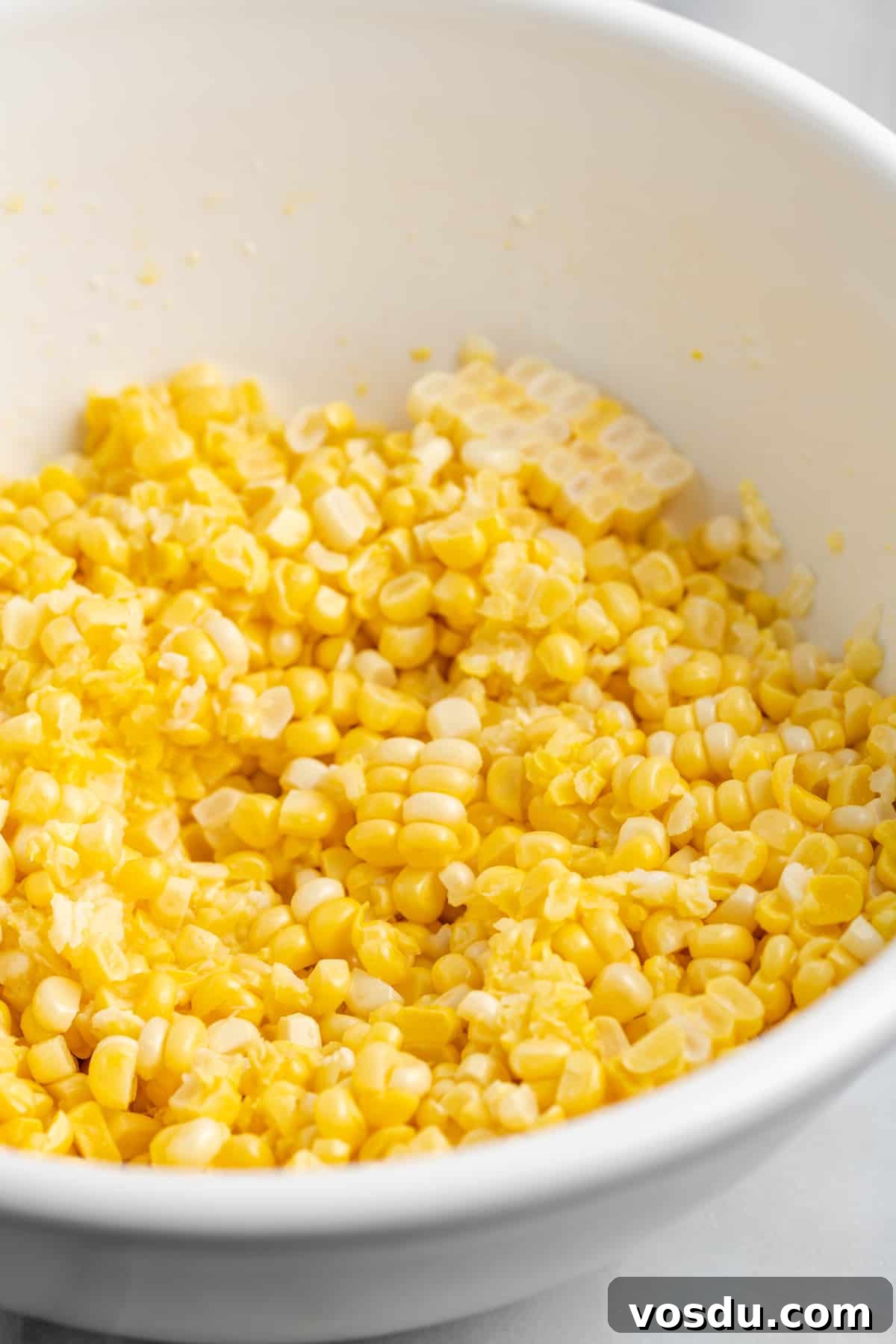 Fresh yellow corn in white bowl