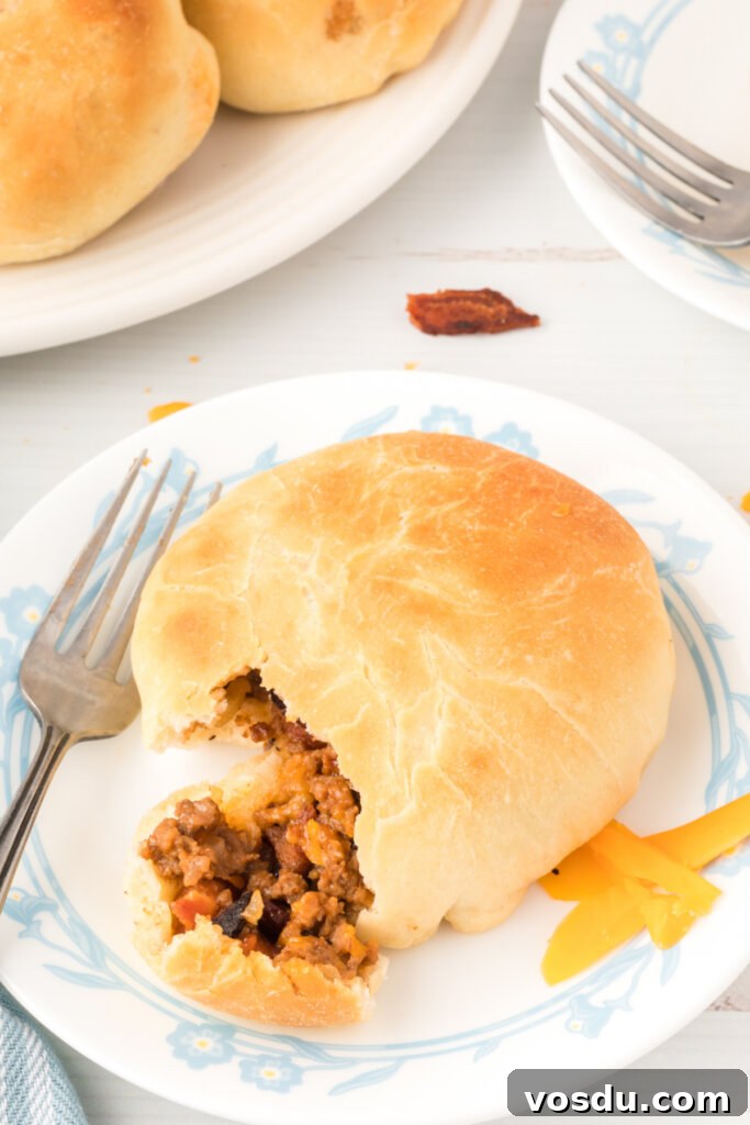 bbq bacon cheeseburger bun on plate with fork