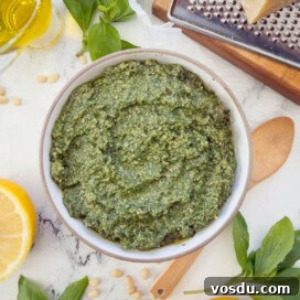 A bowl of bright green Genovese pesto, classic Italian basil pesto.